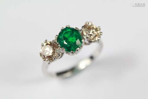 An 18ct White Gold Emerald and Diamond Three-stone Ring, The ring set with a 7 x 6 mm emerald surrounded by two diamonds approx 60 pts,  size M+  , approx 3