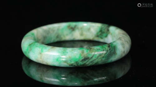 A JADEITE CARVED BANGLE