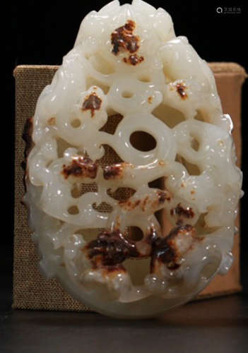 A HETIAN JADE CARVED HOLLOW DRAGON PENDANT