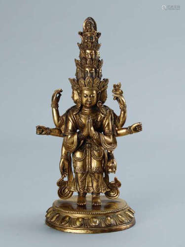 A GILT BRONZE MULTI-ARM BUDDHA