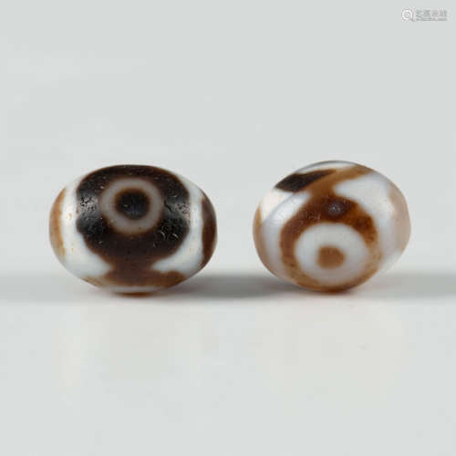 PAIR OF THREE-EYED TIBETAN DZI BEADS