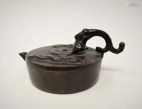 A BRONZE WATER DROP CONTAINER WITH DRAGONFLY
