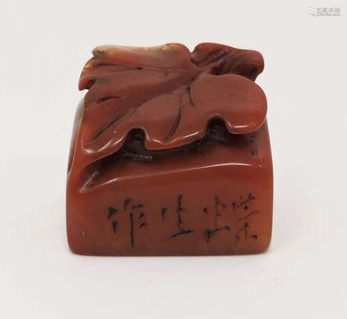 A SMALL RED STONE SEAL WITH INSCRIPTION