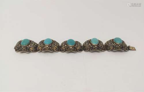 A GILT SILVER BRACELET WITH TURQUOISE STONES