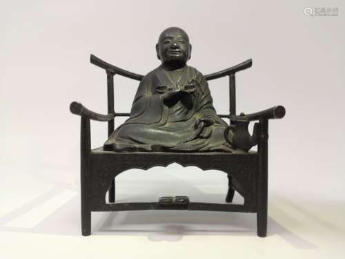 A METAL STATURE OF A MONK