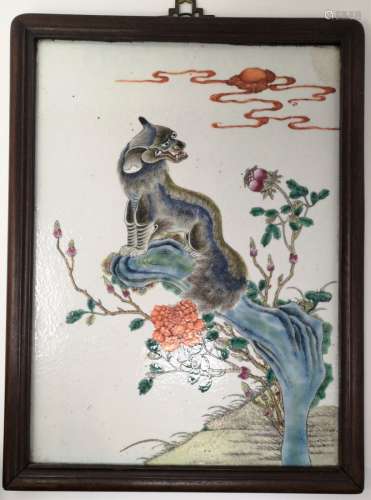 A PORCELAIN PLAQUE WITH AUSPICIOUS BEAST LOOKING AT