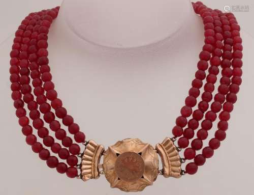 Necklace with grenades attached to a yellow gold strip,