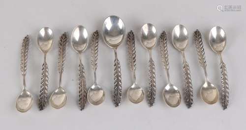 Twelve silver spoons, 833/000, 11 teaspoons and 1 sugar