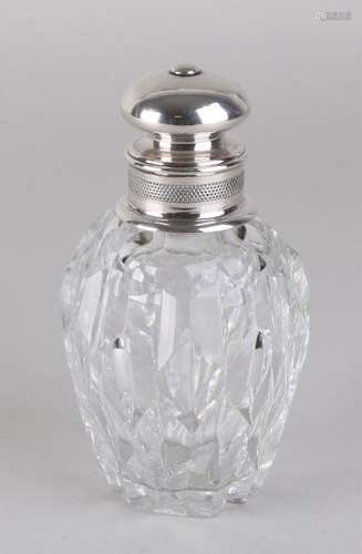 Crystal tea canister with silver collar and cap.