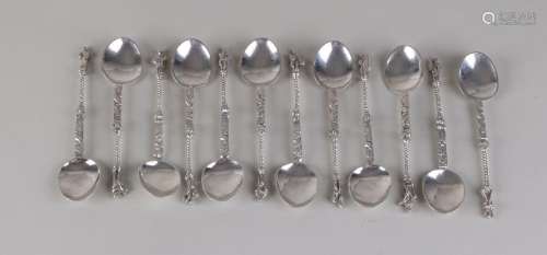 Twelve silver spoons, 833/000, with a machined and