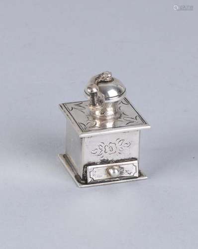 Silver miniature in the shape of a coffee grinder,