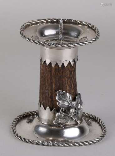 A handmade silver candlestick with a portion of deer