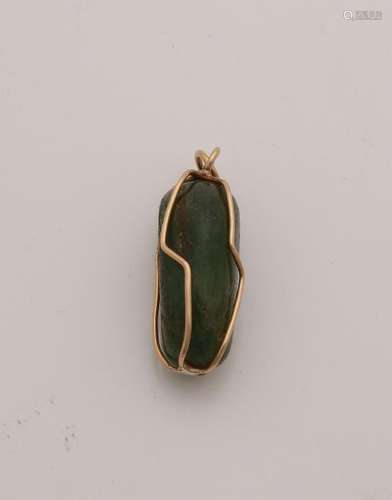 Jade stone trapped in a yellow gold set made from wire.