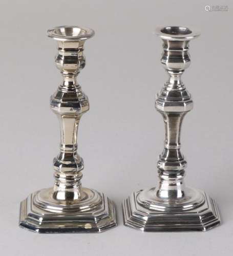 Two small candlesticks, 835/000, on a square contoured