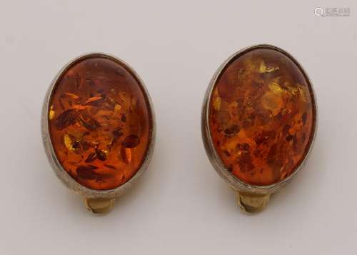 Gold on silver ear clips with an oval cabouchon amber.