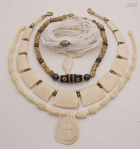 Five necklaces made from carved bone, lucky beads and