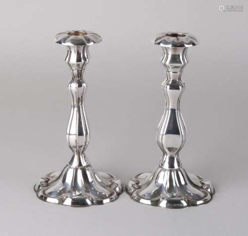 Two silver table candlesticks, 830/000, on a round base