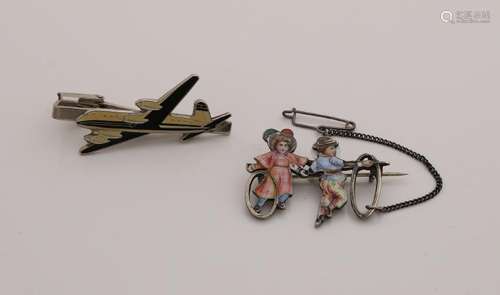 Silver brooch and a white metal tie clip with airplane.