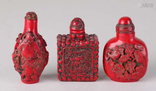 Three old Chinese red lacquer snuffbottles. 20th