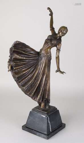 Bronze dancing lady on black marble base. 21st century.