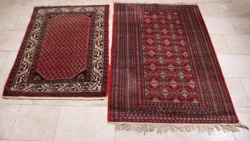 Two ancient Persian rugs. Dark red / floral.