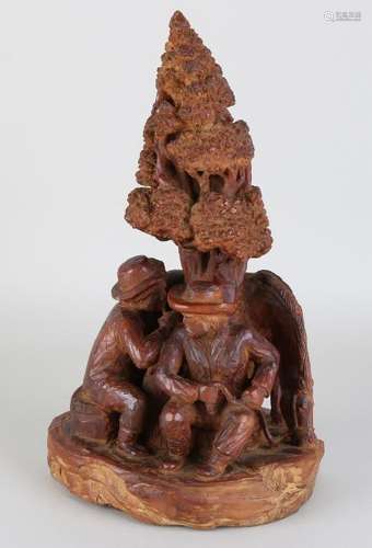 Wood carved sculpture. Two men under tree with horse