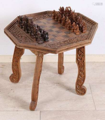 Old Indonesian chess game on wood-chess table. 20th