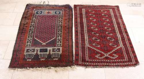 Two old Persian prayer rugs in the color red / brown.