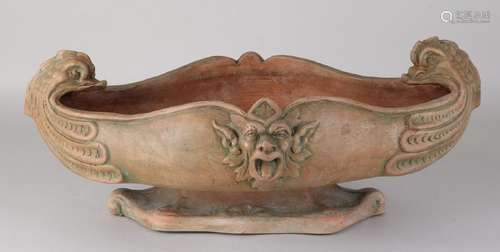 Large old terracotta jardiniere with fish heads and