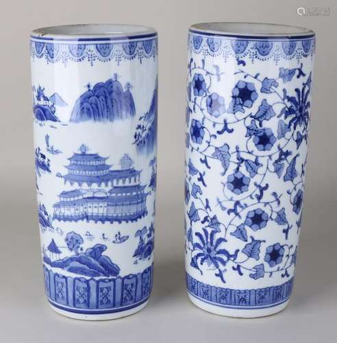 Two blue Chinese brush pots. Once with a floral decor.