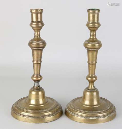 Two antique brass candle holders, one repaired and