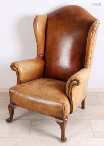 Antique leather ear-chair with beautiful patina. Circa