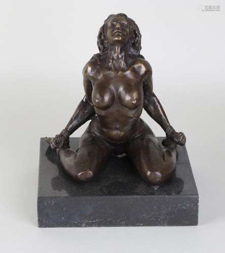 Bronze nude woman with bondage on black marble base.