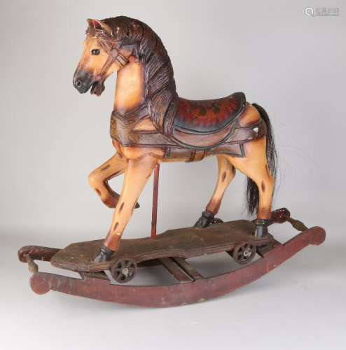 Decorative wood-carved rocking horse after an antique