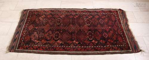 Old / antique Persian rug in dark earth tones.