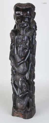 Large African wood-carved statue with many figures.