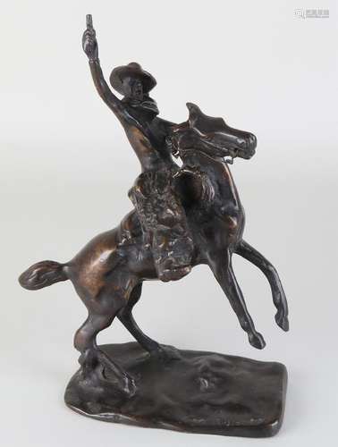 Bronze cowboy on horseback. Smoking up. Signed CM