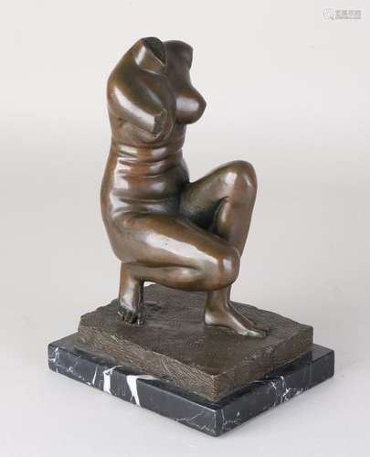 Old bronze figure on a black marble base. Ladies