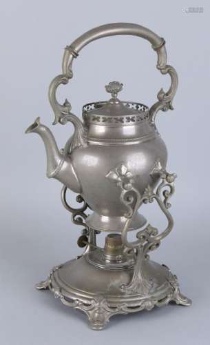 Antique nickel-plated tea pot on stove. Circa 1900.