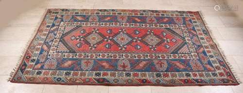 Ancient Persian rug in warm earth tones. Floral. 20th