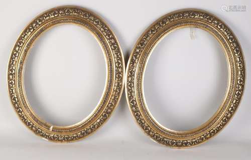 Two 19th century gilt oval frames with tendrils.