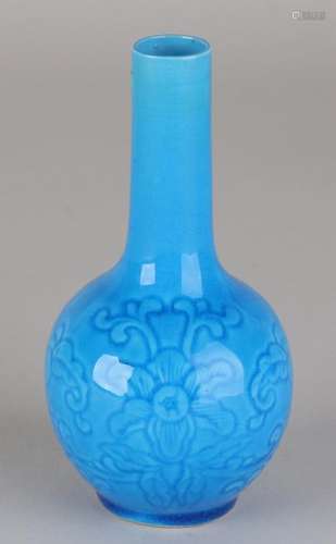 Old Chinese porcelain vase with blue glaze and floral