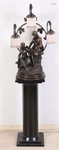 Bronze table lamp with figures under tendrils. On