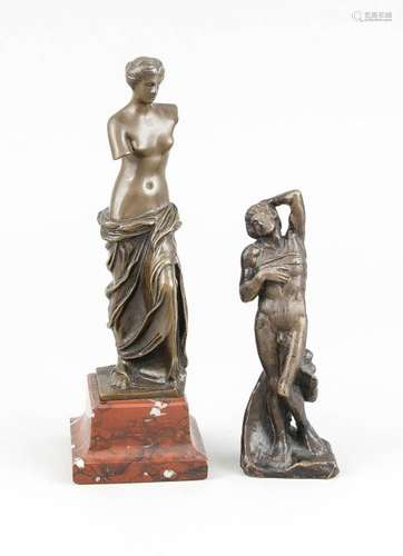 Two antique bronze Greek figurines. One on a red marble