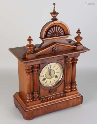 Antique walnut table clock with four Corinthian
