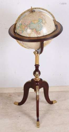 Decorative world globe on wooden stand. With brass