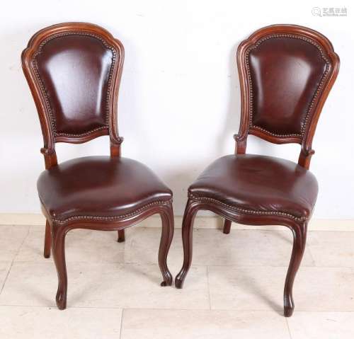 Two antique mahogany chairs with leather upholstery.