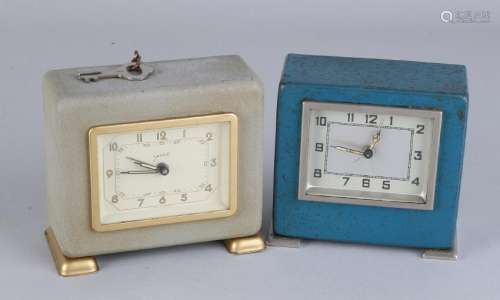 Two arm-louse alarm clocks with coin throw in. With