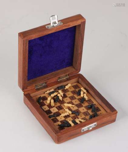 Small miniature chess set made of wood. 20th century.