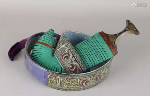 Decorative dagger from Yemen with worked brocade belt.